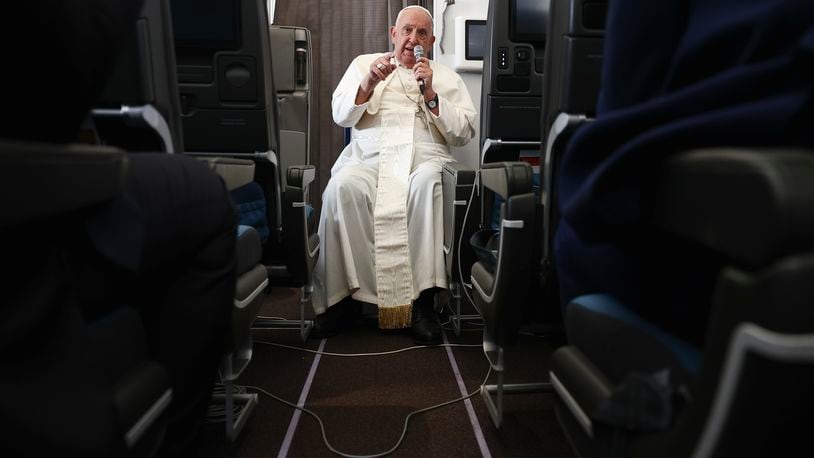 Pope Francis holds a news conference aboard the papal plane on his flight back after his 12-day journey across Southeast Asia and Oceania, Friday, Sept. 13, 2024. (Guglielmo Mangiapane/Pool Photo via AP)