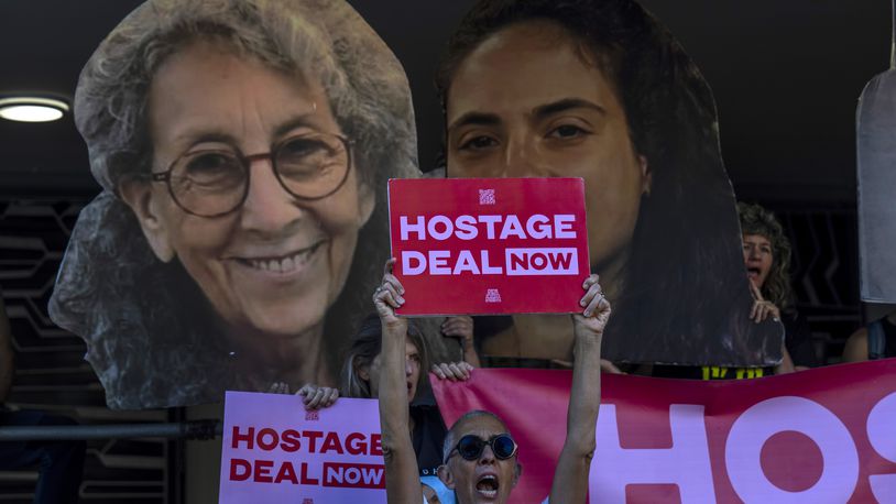 Relatives and supporters of Israeli hostages held by Hamas in Gaza hold photos of their loved ones during a protest calling for their return in Tel Aviv, Israel, Thursday, Aug. 15, 2024. (AP Photo/Ariel Schalit)