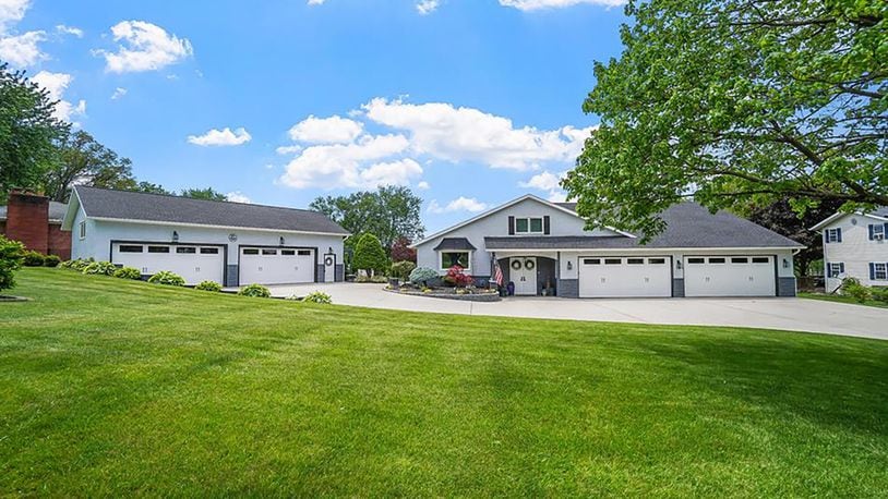 The front of the home has a concrete circular driveway and an attached four-car and detached four-car garage, both with new rubber flooring. CONTRIBUTED PHOTOS