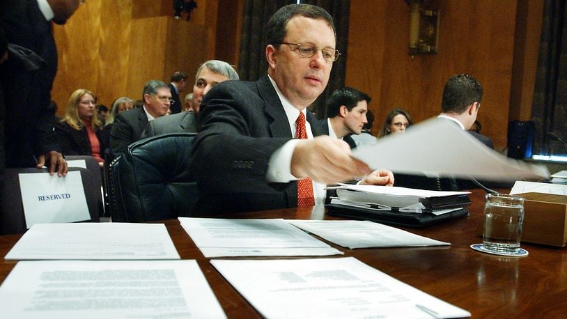 In this Friday, Feb. 10, 2006 file photo, former FEMA Director Michael Brown arranges reference documents prior to testifying before the Senate Homeland Security and Governmental Affairs Committee on Capitol Hill in Washington, about the response to Hurricane Katrina. Head of FEMA when Katrina hit on Aug. 29, 2005, Brown resigned the following month, widely criticized for his handling of the disaster. He defended himself in his 2011 book, "Deadly Indifference: The Perfect (Political) Storm: Hurricane Katrina, The Bush White House, and Beyond." He now hosts a talk show on Denver's KHOW-FM. (AP Photo/Dennis Cook)