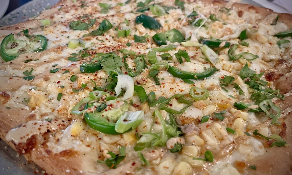 Street Corn pizza on gluten-free crust from Pies & Pints at The Greene in Beavercreek. NATALIE JONES/STAFF