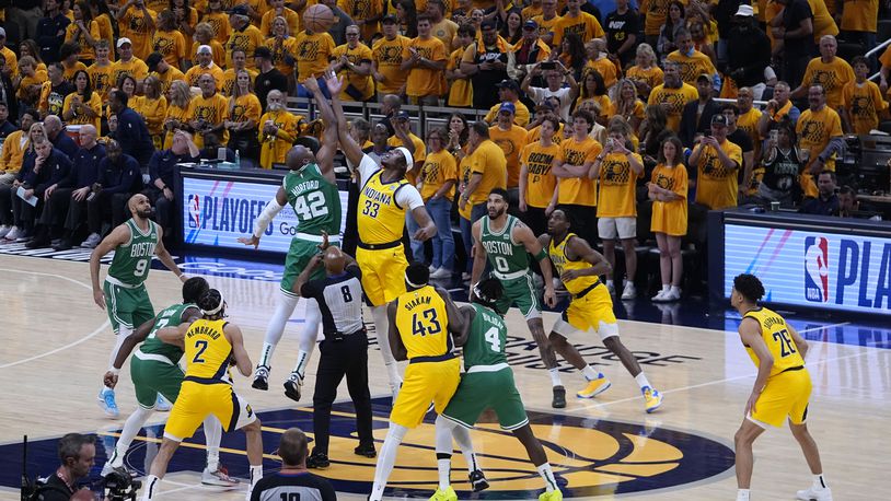 Boston Celtics center Al Horford (42) fights for the opening tip with Indiana Pacers center Myles Turner (33) during the first half of Game 3 of the NBA Eastern Conference basketball finals, Saturday, May 25, 2024, in Indianapolis. (AP Photo/Darron Cummings)