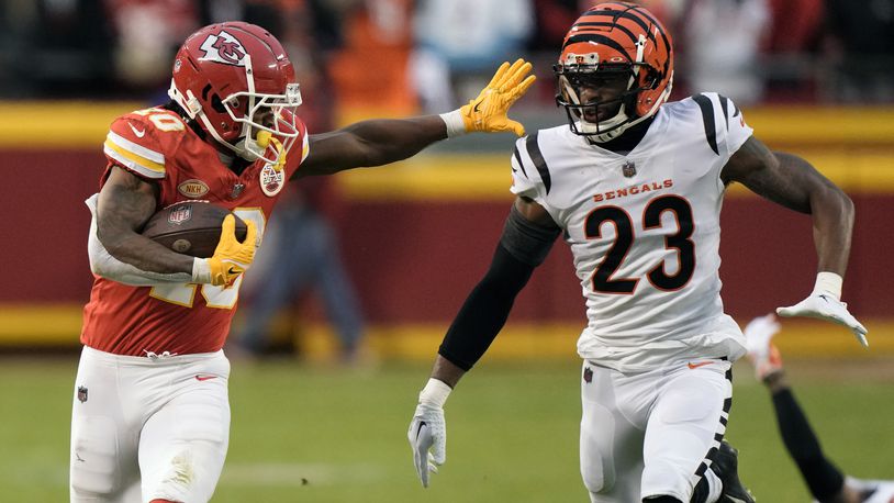 Kansas City Chiefs running back Isiah Pacheco runs for a first down as Cincinnati Bengals safety Dax Hill (23) defends during the first half of an NFL football game Sunday, Dec. 31, 2023, in Kansas City, Mo. (AP Photo/Charlie Riedel)