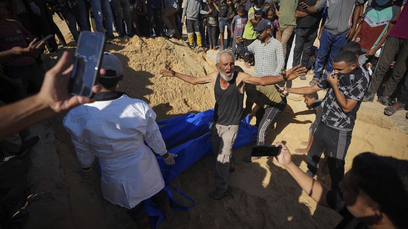 People bury the bodies of Palestinians taken by the Israeli military during operations in Gaza and returned this week, in Khan Younis, Gaza Strip, Thursday, Sept. 26, 2024. (AP Photo/Abdel Kareem Hana)