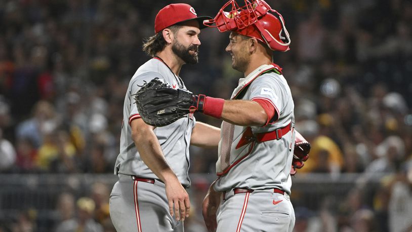 Cincinnati Reds relief pitcher Casey Kelly celebrates with catcher Luke Maile after defeating the Pittsburgh Pirates 10-2 during a baseball game, Saturday, Aug. 24, 2024, in Pittsburgh. (AP Photo/Barry Reeger)