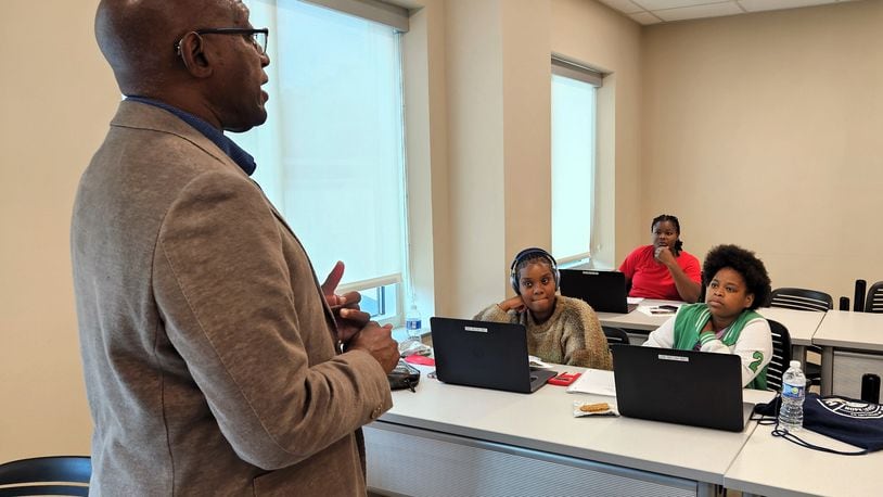 Sinclair Community College Senior Advisor to the President and Chief Diversity Officer Michael Carter talks with recent high school graduates at the Hope Center for Families about success strategies and identifying and achieving goals. Courtesy of Sinclair Community College