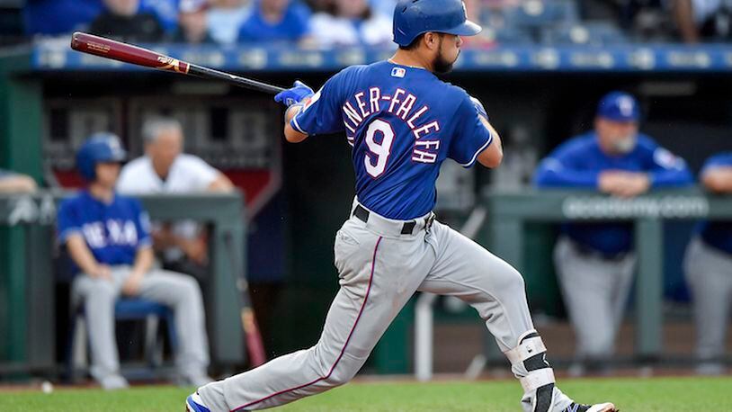 Texas Rangers' Adrian Beltre follows through on a run-scoring