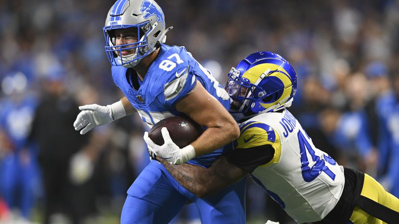 Detroit Lions tight end Sam LaPorta (87) runs after a catch as Los Angeles Rams safety John Johnson III (43) makes the tackle during the first half of an NFL football game in Detroit, Sunday, Sept. 8, 2024. (AP Photo/David Dermer)