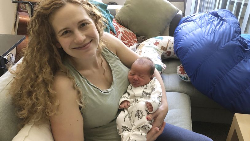 In this photo provided by Liz Chrastil, a neuroscientist with the University of California, Irvine, she her holds her newborn son in May 2020. (Courtesy Liz Chrastil via AP)