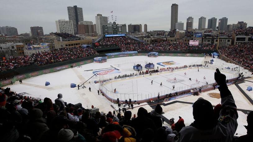 FILE - Fans cheer during the first period of the NHL Winter Classic hockey game between the Detroit Red Wings and the Chicago Blackhawks at Wrigley Field in Chicago, Jan. 1, 2009. (AP Photo/M. Spencer Green, File)