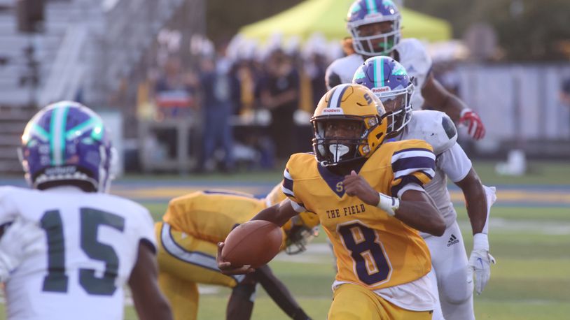 Springfield's Sherrod Lay Jr. runs against Winton Woods on Friday, Aug. 23, 2024, in Springfield. David Jablonski/Staff