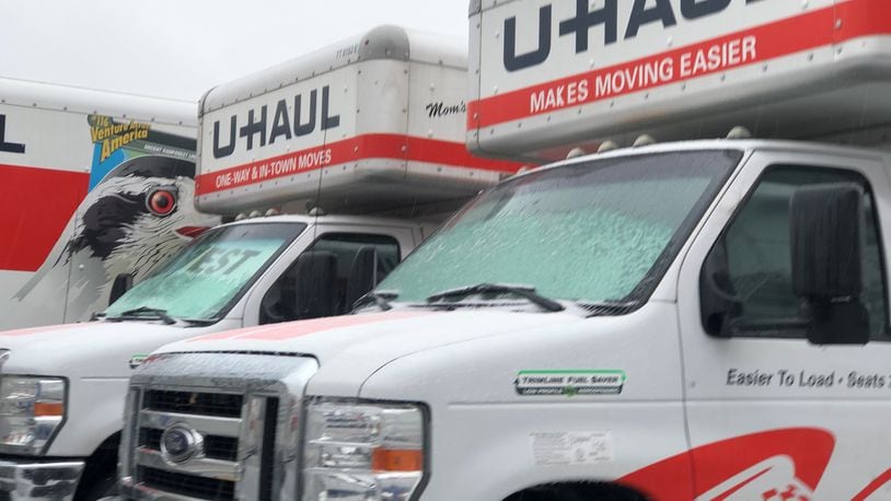 U-Haul moving trucks parked on a lot on East Third Street in Dayton. CORNELIUS FROLIK / STAFF