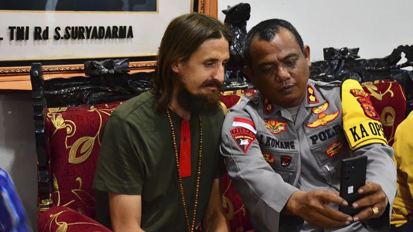 In this photo released by Cartenz Peace Task Force (Satgas Damai Cartenz) of the Indonesian security forces, New Zealand pilot Phillip Mehrtens, left, who was held hostage for more than a year in the restive Papua region, sits with a police officers after his release, in Timika, Papua province, Saturday, Sept. 21, 2024. (Satgas Damai Cartenz via AP)