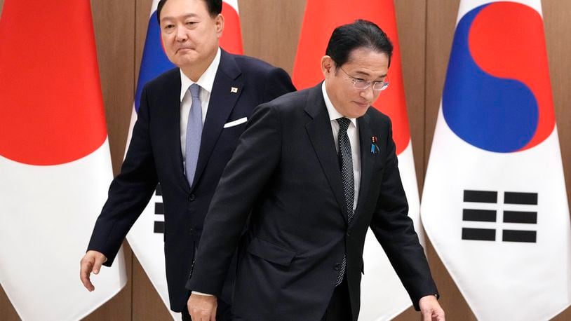 South Korean President Yoon Suk Yeol, left, and Japanese Prime Minister Fumio Kishida, right, walk to their chairs during a meeting at the Presidential Office in Seoul, South Korea, Friday, Sept. 6, 2024. (AP Photo/Lee Jin-man, Pool)