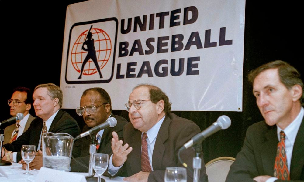 FILE - Agent Dick Moss, second from right, Donald Fehr's predecessor as general counsel of the Major League Players Association, answers a question at a New York news conference, Nov. 1, 1994, announcing the formation of the United Baseball League. From left are Smith College economics professor Andrew Zimbalist; Rep. John Bryant, D-Texas; former major leaguer Curt Flood; Moss, and Robert Mrazek. (AP Photo/Marty Lederhandler, File)