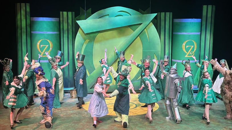 The cast of La Comedia Dinner Theatre's production of "The Wizard of Oz" performs "Merry Old Land of Oz." PHOTO BY JUSTIN WALTON