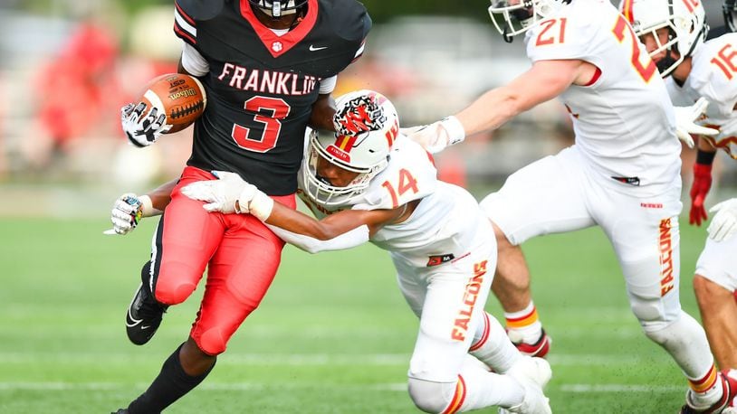 Franklin's Malachi Gipson (3) is tackled by Fenwick's Sean Heberling (14) during their season opener on Friday night at Franklin's Atrium Stadium. Kyle Hendrix/CONTRIBUTED