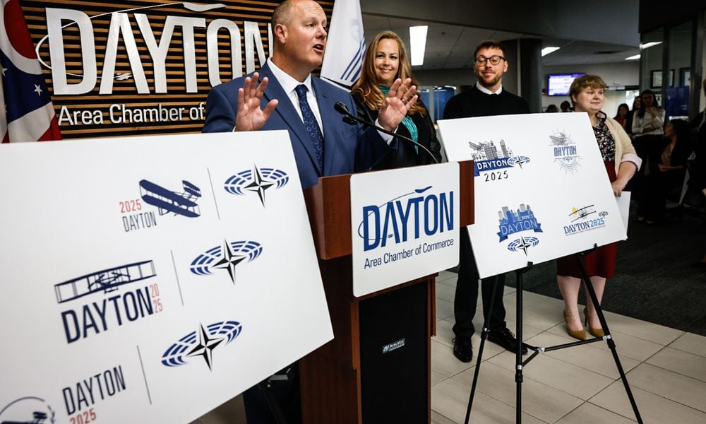 From left, President and CEO of the Dayton Area Chamber of Commerce Chris Kershner Graphic Designers Kim Swigart, Josh Trippier and Elizabeth Kimmel showoff their NATO Spring Parliamentary Assembly logos at the Dayton Area Chamber of Commerce offices on Main Street Wednesday October 9, 2024. JIM NOELKER/STAFF