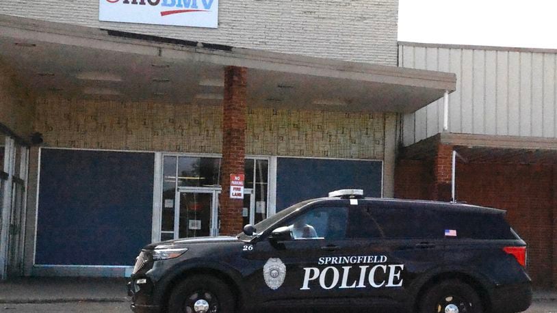 A Springfield police officer sits outside the closed Ohio BMV in the Southern Village Shopping Center Friday, Sept. 13, 2024. BILL LACKEY/STAFF