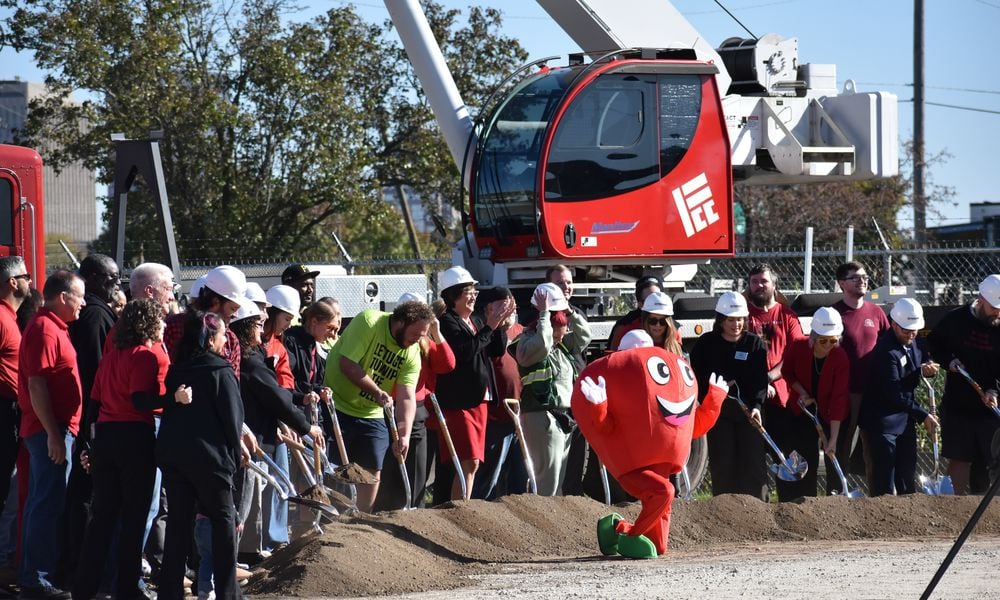 Dayton Foodbank Inc. workers, volunteers and other team members join in breaking ground at the location of a new $4.5 million community building for the Foodbank. SAM WILDOW\STAFF