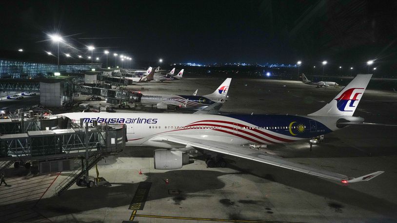 A Malaysia airlines plane parked at Kuala Lumpur International Airport in Sepang, Malaysia, Monday, June 24, 2024. Malaysia Airlines says one of its plane en route to Bangkok made a U-turn back to Kuala Lumpur International Airport after experiencing a "pressurization issue." (AP Photo/Vincent Thian)