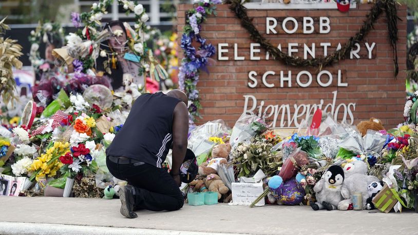 FILE - Reggie Daniels pays his respects a memorial at Robb Elementary School, Thursday, June 9, 2022, in Uvalde, Texas. The 19 fourth-graders and two teachers killed at the elementary school are being remembered, Friday, May 24, 2024 as the second anniversary of the one of the deadliest school shootings in U.S. history is marked. (AP Photo/Eric Gay)