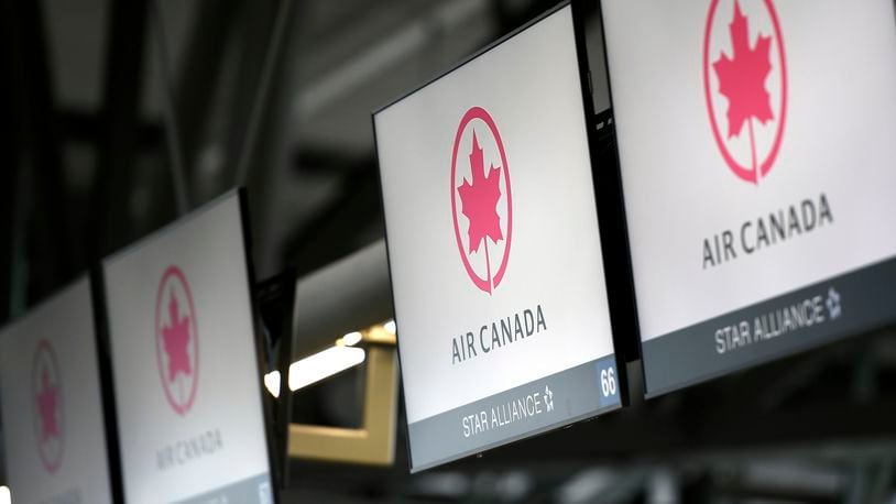 FILE - Air Canada check-in screens are seen at the Ottawa International Airport in Ottawa, Ontario, May 16, 2020. (Justin Tang/The Canadian Press via AP, File)