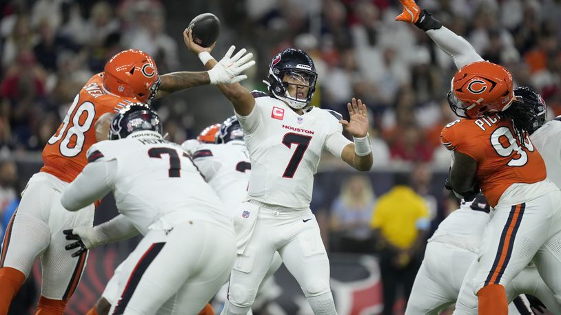 Houston Texans quarterback C.J. Stroud (7) throws under pressure from Chicago Bears defensive lineman Montez Sweat (98) and defensive lineman Zacch Pickens, right, during the first half of an NFL football game Sunday, Sept. 15, 2024, in Houston. (AP Photo/Eric Christian Smith)