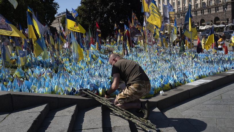 A veteran pays his respect at a makeshift memorial for fallen Ukrainian soldiers during the Ukrainian Independence Day on Independence Square in Kyiv, Ukraine, Saturday, Aug. 24, 2024. (AP Photo/Efrem Lukatsky)