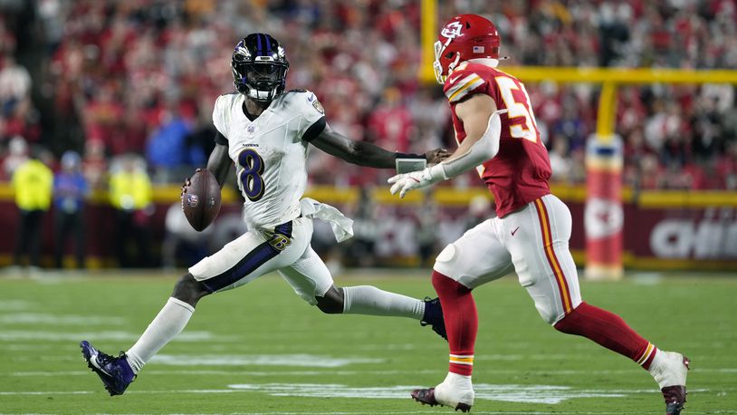 Baltimore Ravens quarterback Lamar Jackson (8) scrambles as Kansas City Chiefs linebacker Leo Chenal defends during the second half of an NFL football game Thursday, Sept. 5, 2024, in Kansas City, Mo. (AP Photo/Ed Zurga)