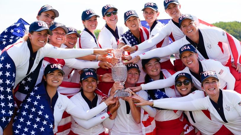 United States players poses for photographs after the United States won the Solheim Cup golf tournament against Europe at the Robert Trent Jones Golf Club, Sunday, Sept. 15, 2024, in Gainesville, Va. (AP Photo/Matt York)