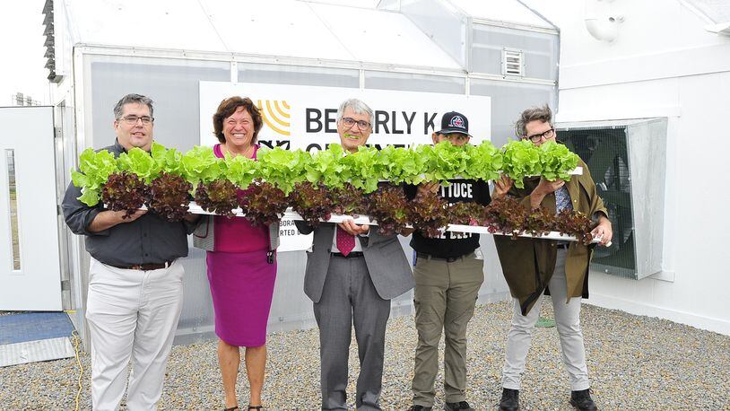 From left: Greg Greene, Michelle Riley, Tom Greene, James Hoffer and Charlie Greene display some hydroponic lettuce from the Beverly K. Greenehouse at the Dayton Foodbank on Aug. 30. HORACE DOZIER / CONTRIBUTED