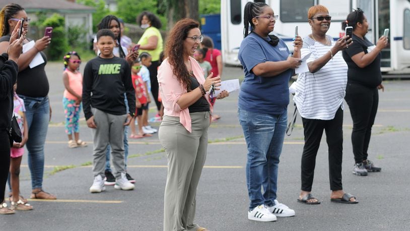 Parents and family members take photos Friday of the class of 2020 graduaton ceremony at the On Purpose Academy and Mentoring Center. MARSHALL GORBY\STAFF