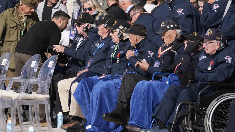 Ukraine's President Volodymyr Zelenskyy, second left, greets World War II veterans at the international ceremony at Omaha Beach, Thursday, June 6, 2024, in Normandy, France. Normandy is hosting various events to officially commemorate the 80th anniversary of the D-Day landings that took place on June 6, 1944. (AP Photo/Virginia Mayo, Pool)