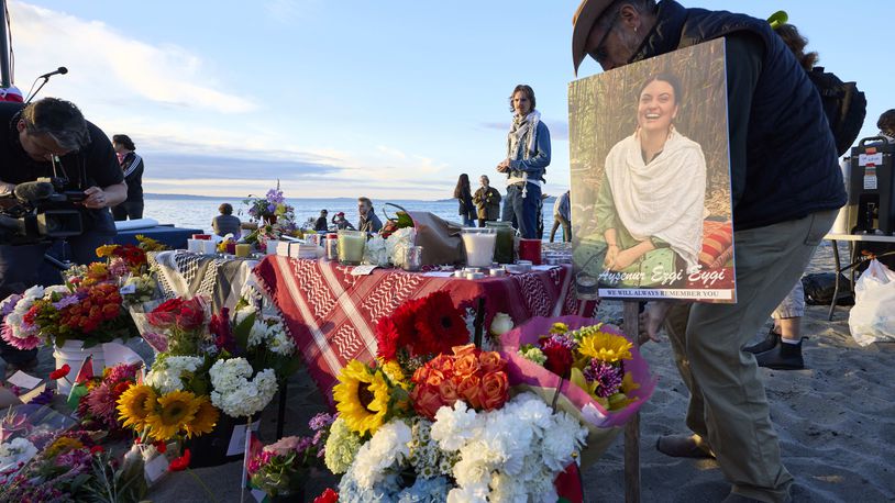 A photo is placed among flowers in memory of the death of the 26-year old Aysenur Ezgi Eygi at vigil on Alki Beach, killed recently in the occupied West Bank, Wednesday, Sept. 11, 2024, in Seattle. Eygi grew up in Seattle, attended Seattle Public Schools and graduated from the University of Washington. (AP Photo/John Froschauer)