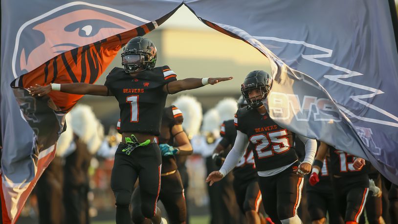 The Beavercreek football team takes the field. Michael Cooper/FILE