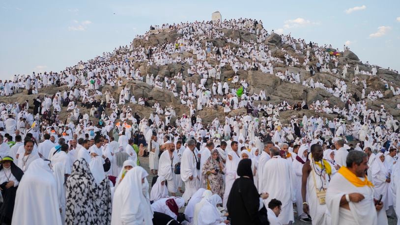 Muslim pilgrims gather at the top of the rocky hill known as the Mountain of Mercy, on the Plain of Arafat, during the annual Hajj pilgrimage, near the holy city of Mecca, Saudi Arabia, Saturday, June 15, 2024. Masses of Muslims gathered at the sacred hill of Mount Arafat in Saudi Arabia for worship and reflection on the second day of the Hajj pilgrimage. The ritual at Mount Arafat, known as the hill of mercy, is considered the peak of the Hajj. It's often the most memorable event for pilgrims, who stand shoulder to shoulder, asking God for mercy, blessings, prosperity and good health. Hajj is one of the largest religious gatherings on earth. (AP Photo/Rafiq Maqbool)