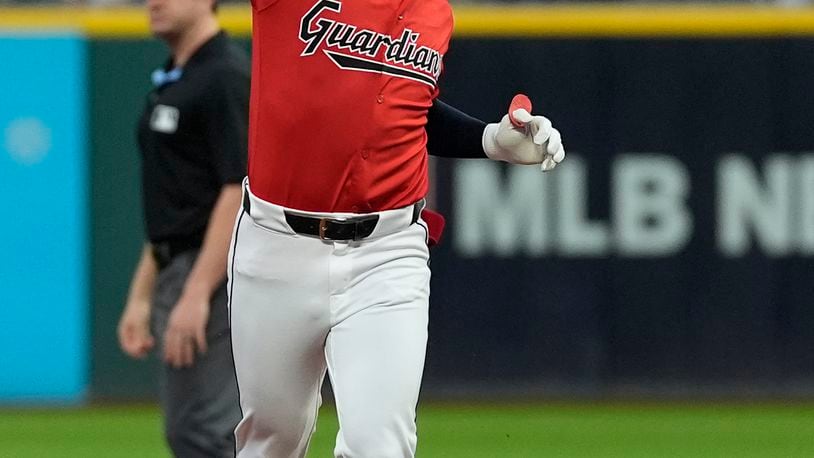 Cleveland Guardians' Steven Kwan celebrates his home run as he runs the bases in the first inning of a baseball game against the Cincinnati Reds in Cleveland, Wednesday, Sept. 25, 2024. (AP Photo/Sue Ogrocki)