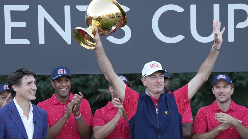 United States team captain Jim Furyk hoist the Presidents Cup as Canada Prime Minister Justin Trudeau looks on at Royal Montreal Golf Club on Sunday, Sept. 29, 2024, in Montreal. (Frank Gunn/The Canadian Press via AP)