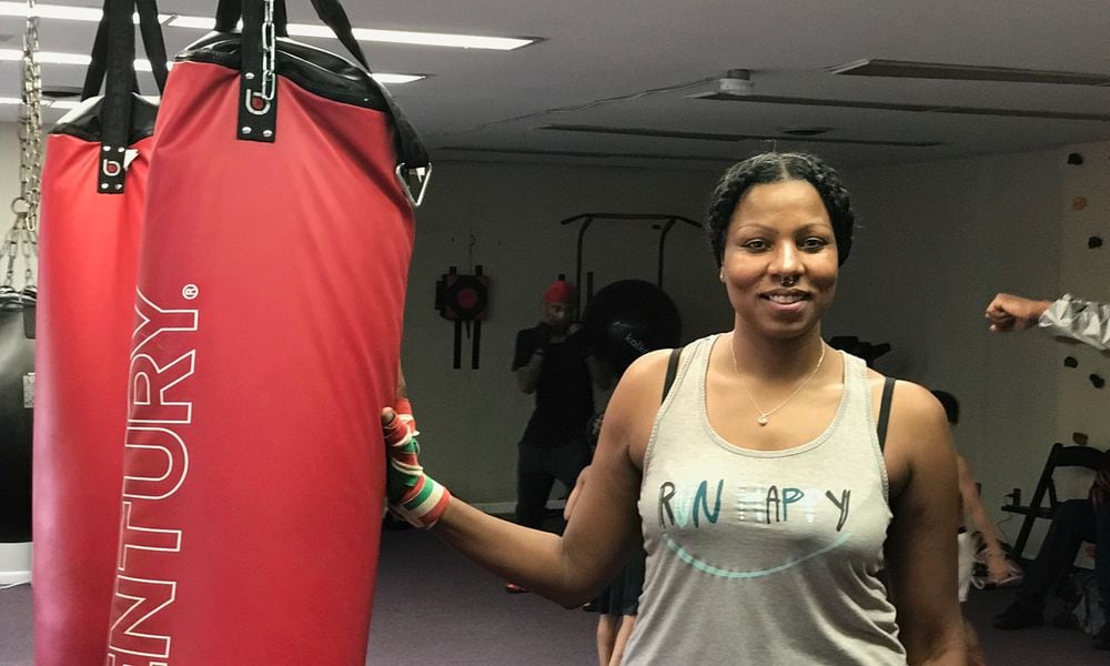 Chia Fei before she starts working on the heavy bag a few evenings ago at the King of Kingz gym in Cincinnati. The 42-year-old mother of three a product of Belmont High and Sinclair Community College who now lives in Kettering has had three pro bouts, all on the road, Her hometown debut is scheduled for October 19 at a gala show at the Flyght Academy in Trotwood. Tom Archdeacon/CONTRIBUTED