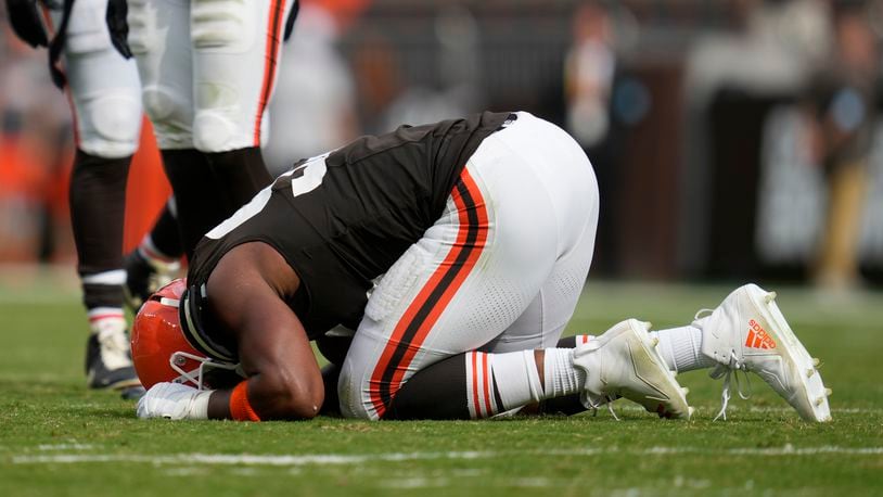 Cleveland Browns' Myles Garrett kneels on the field after an injury in the second half of an NFL football game against the New York Giants, Sunday, Sept. 22, 2024, in Cleveland. (AP Photo/Sue Ogrocki)