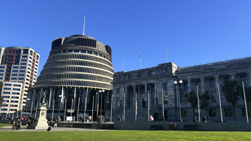 FILE - People arrive at Parliament in Wellington, New Zealand, Wednesday, July 24, 2024. (AP Photo/Charlotte Graham-McLay, File)