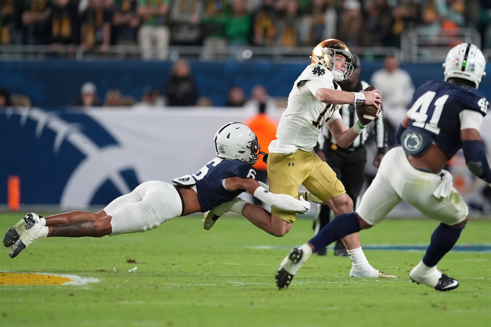 Penn State safety Zakee Wheatley (6) sacks Notre Dame quarterback Riley Leonard (13) during the first half of the Orange Bowl NCAA College Football Playoff semifinal game, Thursday, Jan. 9, 2025, in Miami Gardens, Fla. (AP Photo/Rebecca Blackwell)