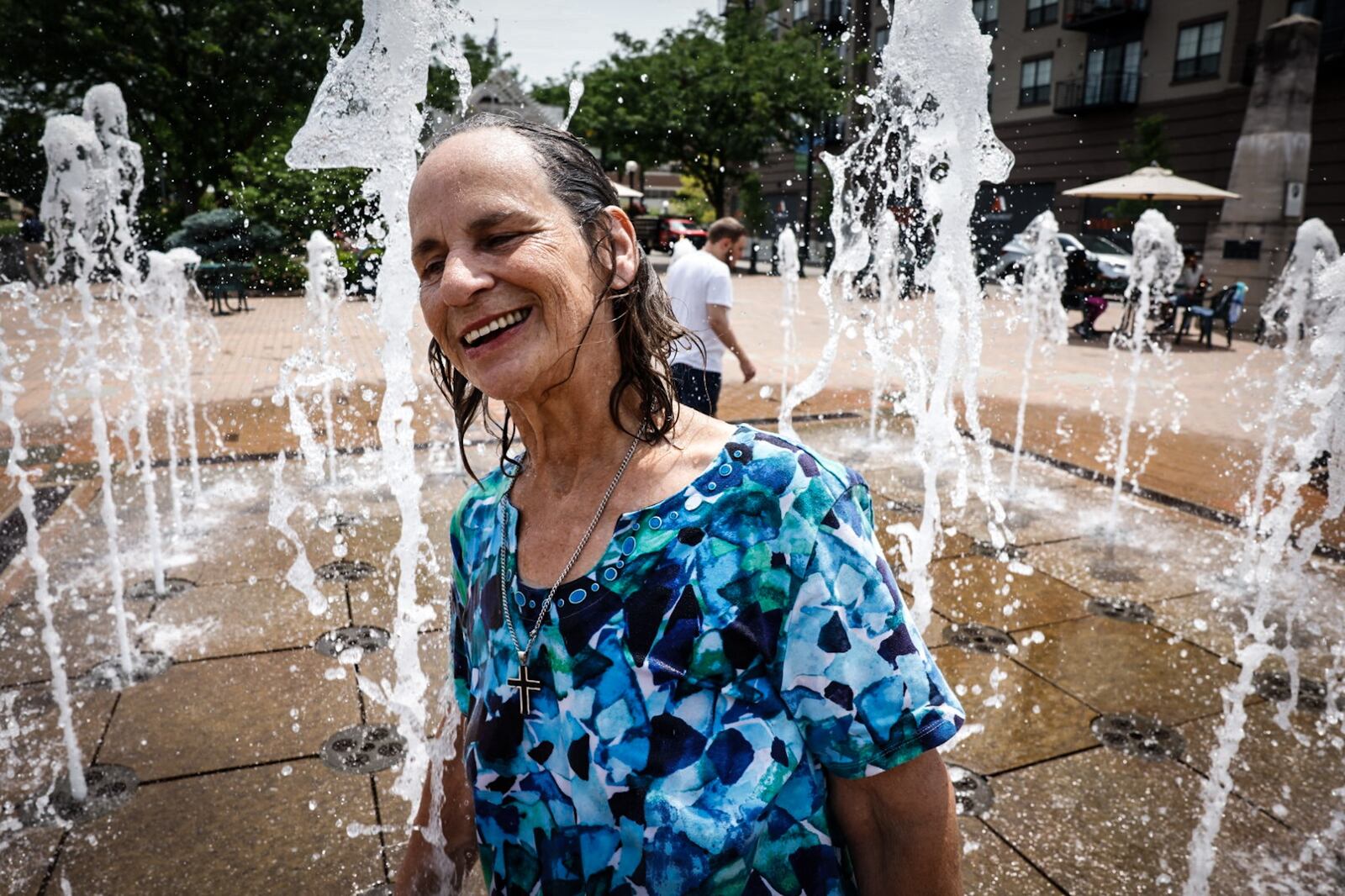 Shauna Doerman from Dayton enjoys the splash pad at RiverScape Metro Park Tuesday June 18, 2024. This week the Dayton area is expecting near100 degree temperatures all week. JIM NOELKER/STAFF