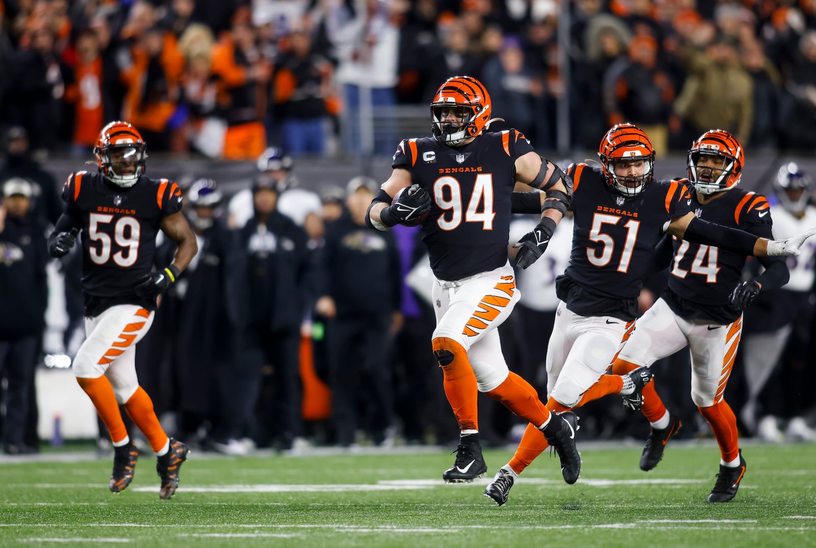 Bengals defensive end Sam Hubbard runs back a 98 yard touchdown during Cincinnati's Wild Card playoff game against the Baltimore Ravens Sunday, Jan. 15, 2023 at Paycor Stadium in Cincinnati. The Bengals won 24-17. NICK GRAHAM/STAFF