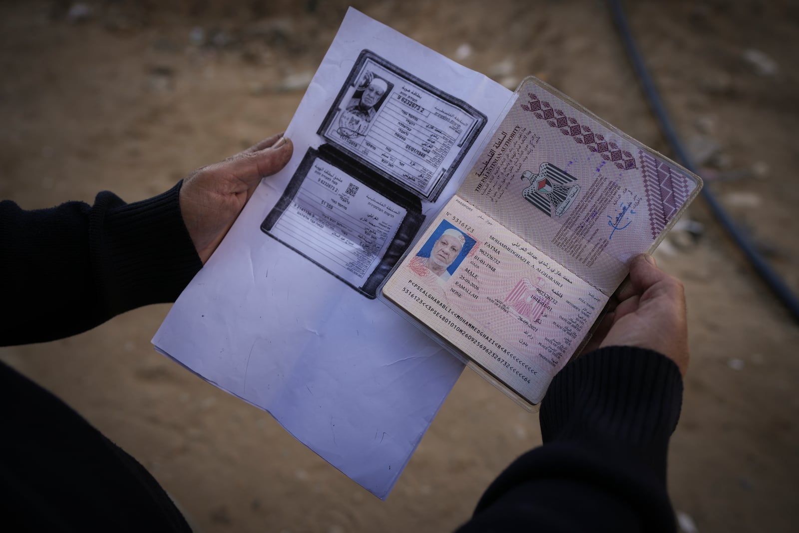 Sabah Alghrabli shows some documents of her husband, Mahmoud Alghrabli, at her home in Khan Younis, Gaza Strip, Nov. 21, 2024. (AP Photo/Abdel Kareem Hana)