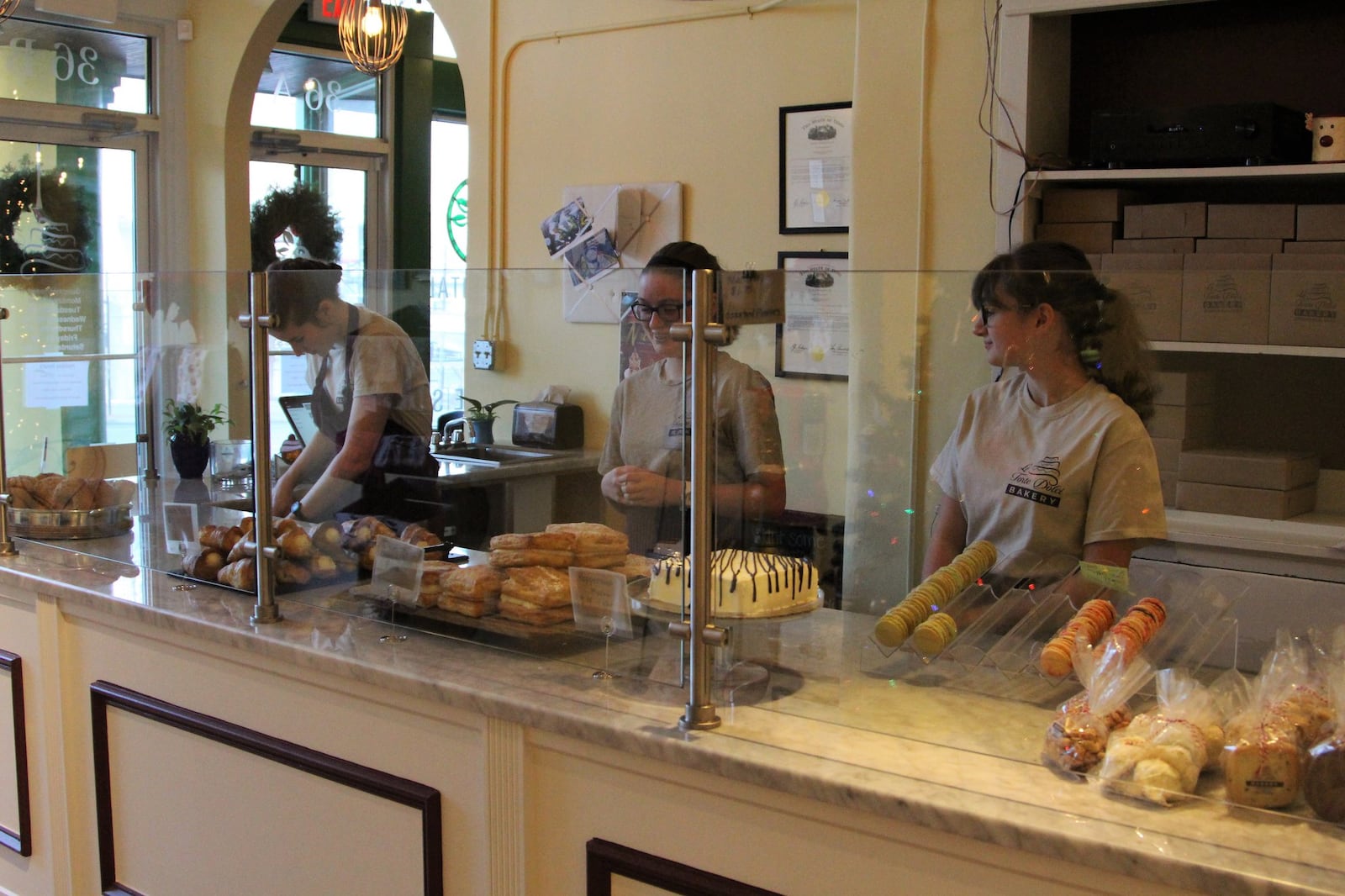 Employees stand behind the counter of downtown Springfield bakery Le Torte Dolci. The owners of the bakery, Dan and Lisa Freeman, hope to open their third downtown European-inspired eatery by March. HASAN KARIM/ Staff