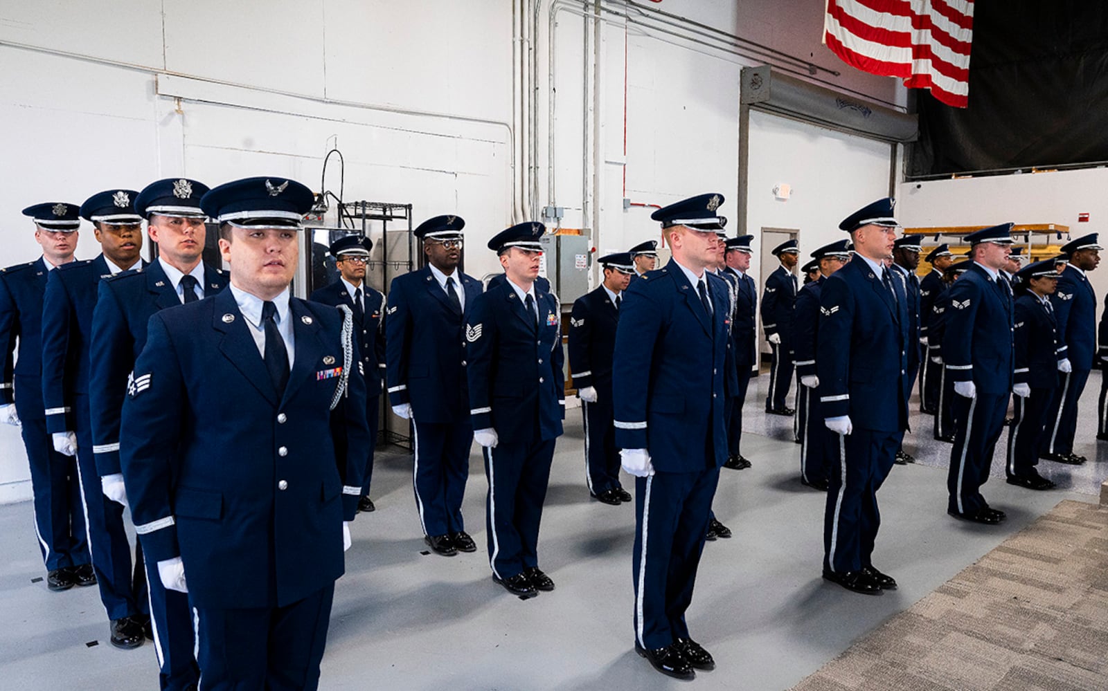 A class of new members of the Wright-Patterson Air Force Base Honor Guard stand at attention during their graduation ceremony on April 25. Thirty-nine Airmen from units across the base underwent more than 50 hours of training to become proficient in the customs and courtesies they will need during their six-month tour with the guard. U.S. AIR FORCE PHOTO/R.J. ORIEZ