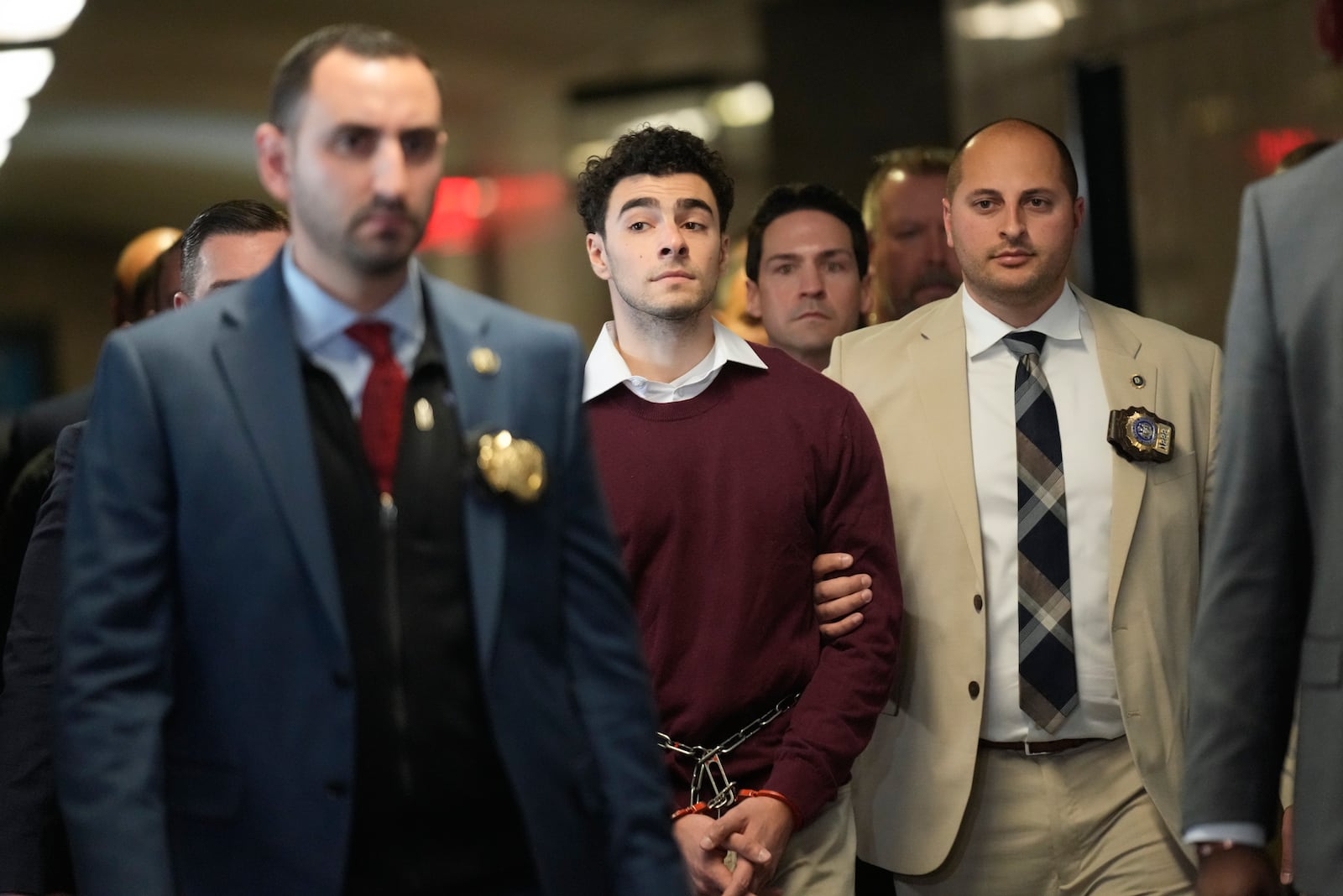 Luigie Mangione is escorted into Manhattan Criminal court for his arraignment in the killing of UnitedHealthcare CEO Brian Thompson, Monday, Dec. 23, 2024, in New York. (AP Photo/Seth Wenig)