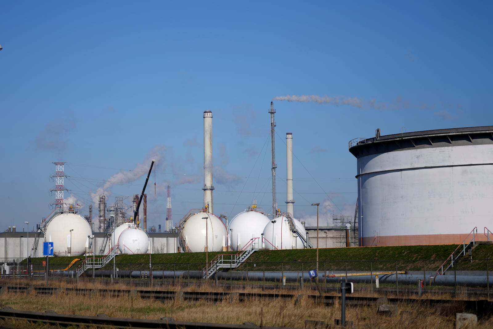 Steam and smoke in front of industrial complexes in the Port of Antwerp in Antwerp, Belgium, Wednesday, Feb. 26, 2025. (AP Photo/Virginia Mayo)